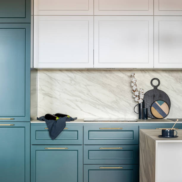 istock Luxury modern and vintage turquoise and white kitchen. Marble wall with white cabinets. Black vase with white dried flowers. Template. 1500566171