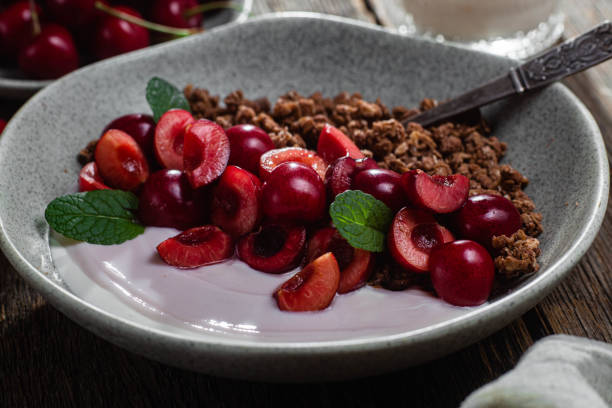 Granola with yogurt and cherries in a bowl