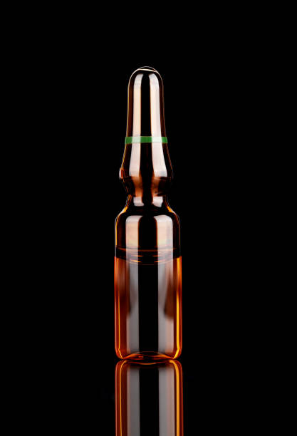 istock Medicine ampoule with reflexion on a black background. 1500573349