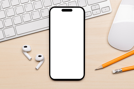 Blank white screen smartphone on a desk, perfect for your design mockup