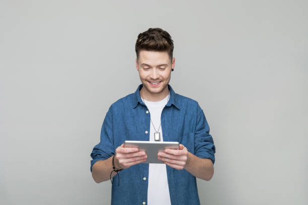 istock Portrait of young man using digital tablet 1500575958