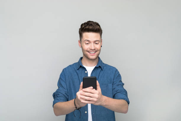 istock Portrait of young man using smart phone 1500576153