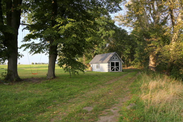 istock Little wooden cottage among trees 1500579872