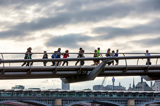 London, UK - 06 Jun 2023: People Crossing the Millenium Bridge over the River Thames in London