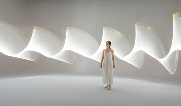 istock Young woman in front of white light trails 1500583527