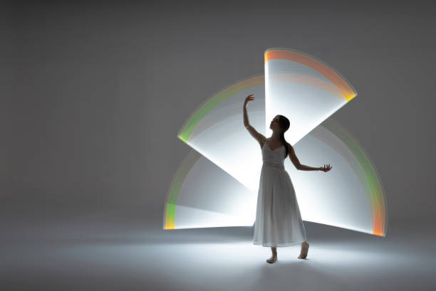 istock Young woman in front of white light trails 1500583530