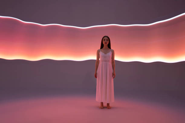 istock Young woman in front of orange light trails 1500583574