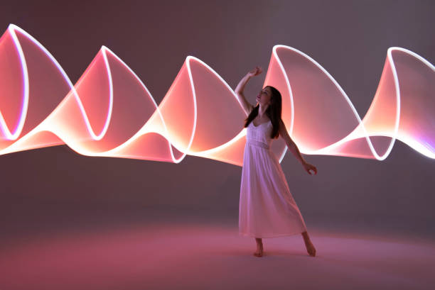 istock Young woman in front of orange light trails 1500583621