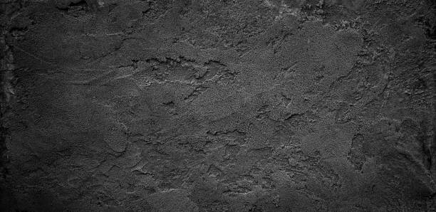 istock Black or dark gray rough grainy stone or sand texture background 1500584043