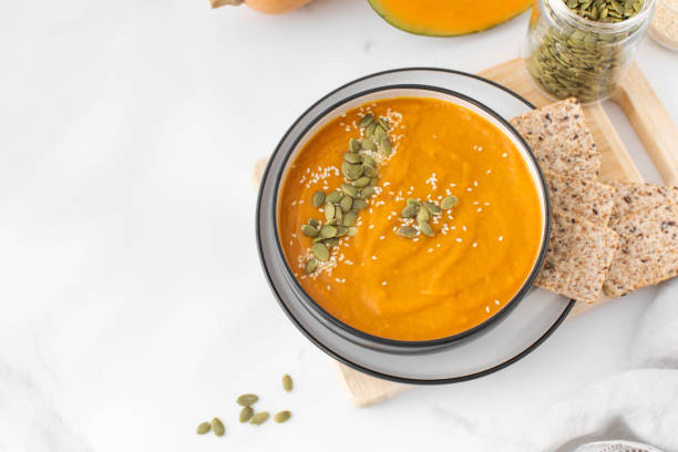 istock A bowl of pumpkin soup with mashed potatoes and seeds. Autumn menu. Copy space 1500584811