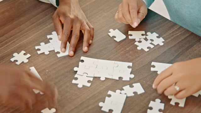 Top view, hands and busines people with puzzle for strategy, planning and company growth vision. Above teamwork, collaboration and jigsaw game piece for solution, problem solving and innovation