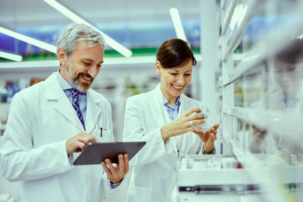 istock A smiling female and male pharmacist doing a product inventory and using a tablet. 1500594525
