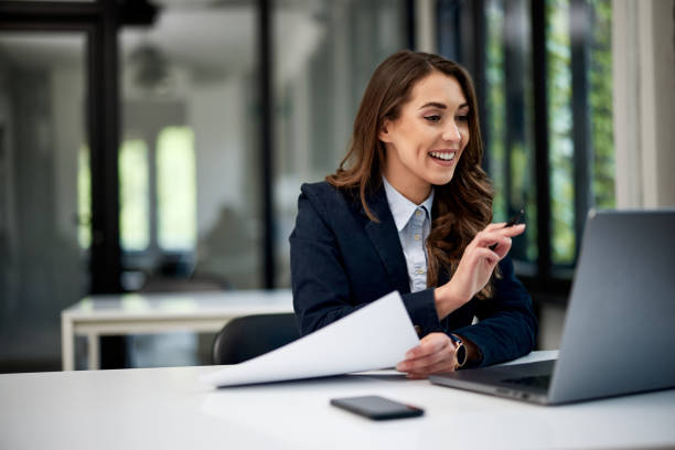 istock A smiling female employee talking with a client on a video call over a laptop. 1500594704