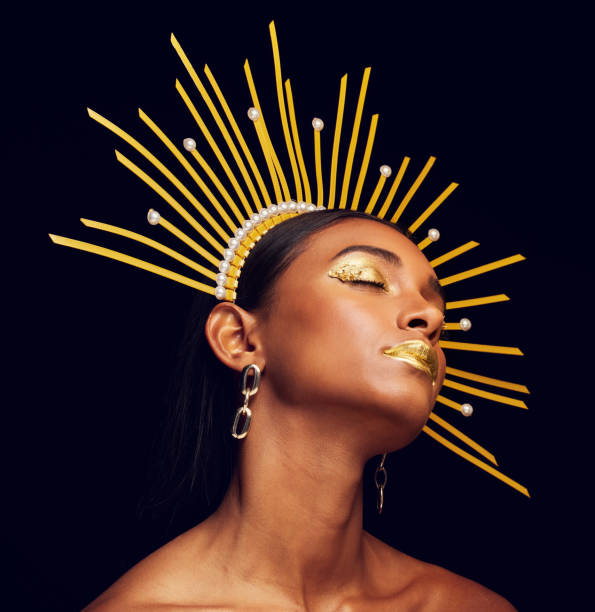 istock Crown, gold makeup and a beauty queen isolated on a black background in a studio. Dreaming. ethereal and an Indian girl with cosmetics, accessories and jewelry for royalty on a dark backdrop 1500600893