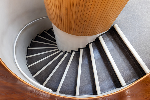 Spiral staircase goes down, top view, abstract architecture photo background
