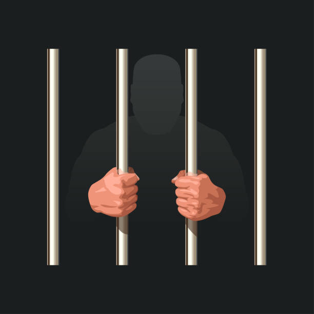 istock hands of prisoner holding metal jail bars 1500603101
