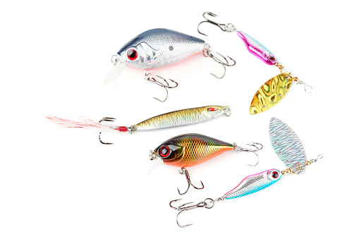 Set of metal and plastic lures for fishing on white background