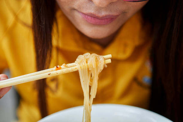 Asian women eating noodles