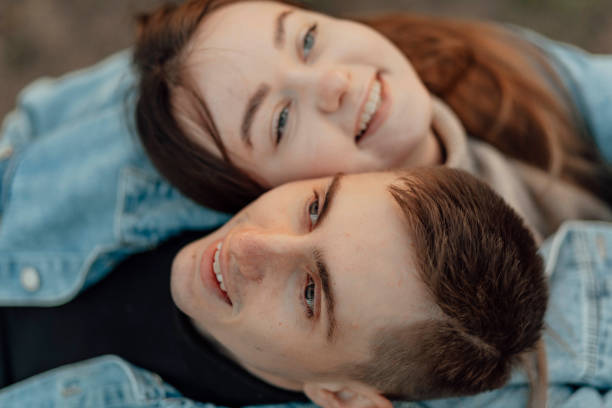 happy young loving young couple relaxing with eyes closed, head on shoulder - human face heterosexual couple women men imagens e fotografias de stock