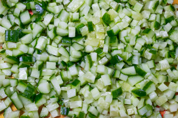 Diced fresh cucumber close-up. Finely chopped vegetable. Natural food cooking background stock photo