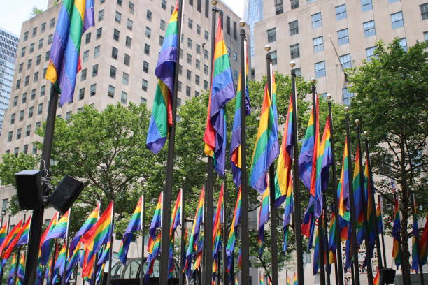 Rainbow Rockefeller Rockefeller Center Plaza decked out in rainbow flags, in celebration of pride, diversity and inclusiveness rockefeller ice rink stock pictures, royalty-free photos & images