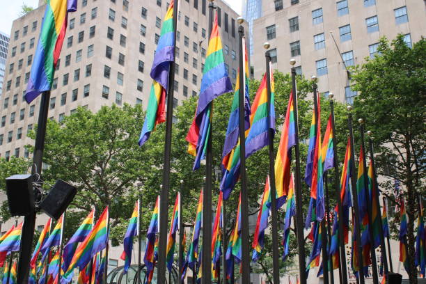 Rainbow Rockefeller Rockefeller Center Plaza decked out in rainbow flags, in celebration of pride, diversity and inclusiveness rockefeller ice rink stock pictures, royalty-free photos & images