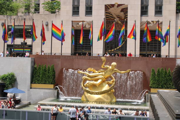 Rainbow Rockefeller Rockefeller Center Plaza decked out in rainbow flags, in celebration of pride, diversity and inclusiveness rockefeller ice rink stock pictures, royalty-free photos & images