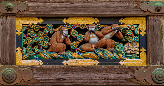 Three wise monkeys, probably the most popular among the carvings in the wooden sacred stable, of Nikko Toshogu. Monkeys are considered to be the guardian deities of horses, and the sculptures of monkeys displayed on the 8 panels satirize the life of humans. The three Japanese macaques representing the principle of \