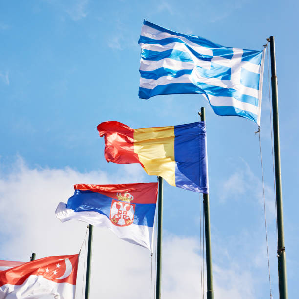 istock Singapore, Romania, Greece, Serbia, flags on sky 1500617876