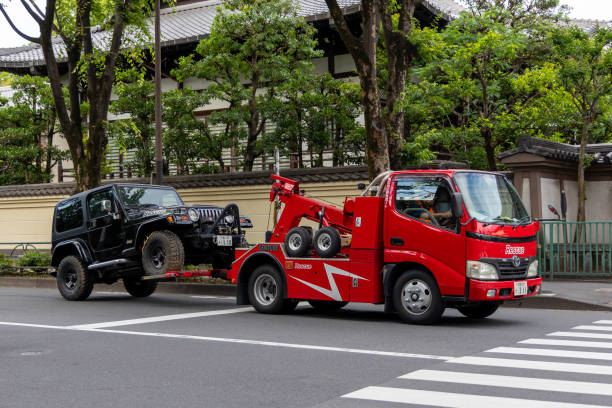 Tokyo, Japan - May 30 , 2023 :  A tow truck moving a car on a street in Tokyo, Japan.
