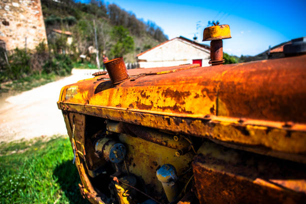 close up of a weathered and rusted old yellow earth moving machine