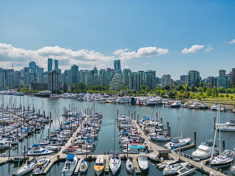 Aerial view of Vancouver BC from Stanley Park. Skyscrapers and boats dot the shoreline.