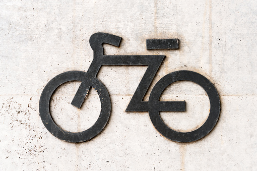 A simple outline sign of a bicycle, on a road sign in Japan.