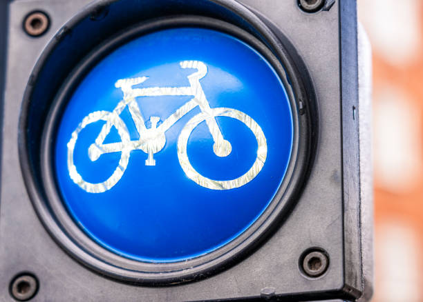 An illuminated blue bicycle traffic light signal in Copenhagen, indicating a bicycle path.