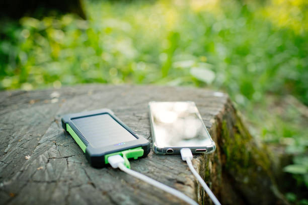 istock Smartphone and solar battery in a park or forest in summer 1500624232