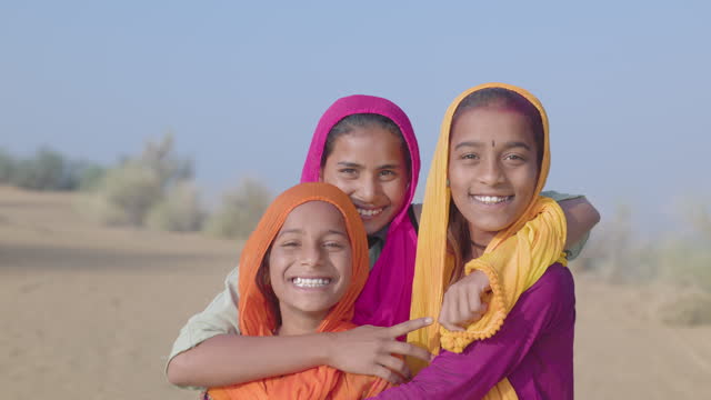 Indian girls posing on a sand dune, desert village, India