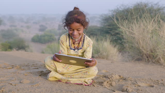 Little girl using digital tablet, India