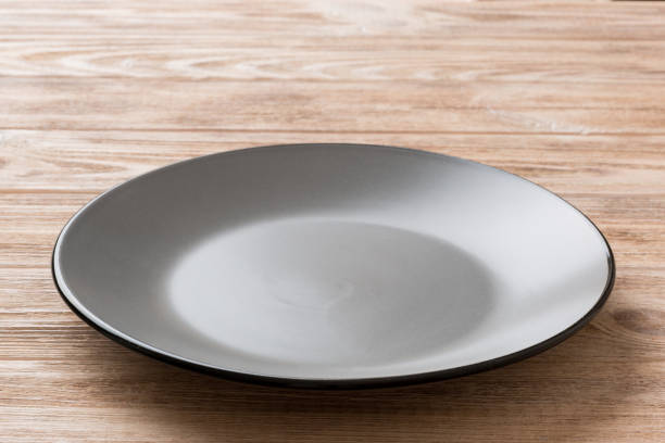 istock Perspective view of empty grey plate on cement background. Empty space for your design 1500627548