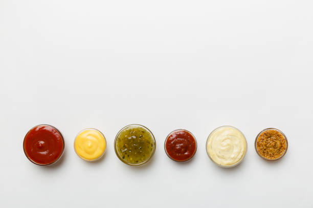 istock Different types of sauces in bowls on a colored Board . Top view. various sauces copy space 1500627550