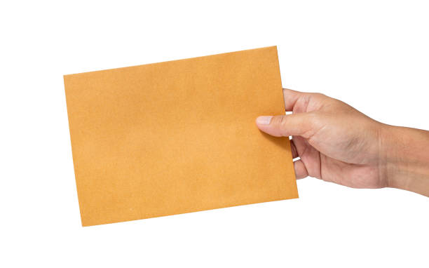istock Man's hand holding envelope isolated on white background. Close up. High resolution product 1500627564