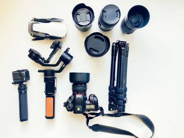 istock Flat lay composition with equipment for professional photographer on white table background. Gimbal, lens, drone, tripod, camera, action camera outdated. Isolated Space for text 1500629795