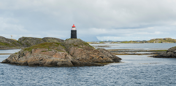 Automated lighthouse on a rock close to Bodo, Norway. Norwegian see with small islands and a picturesque lighthouse. copy space is available. nordic, scandinavia