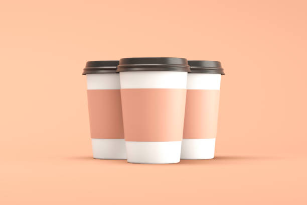 istock Three disposable paper coffee cups with a black lid on a brown background 1500630599