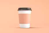 Coffee cup and lid on brown background