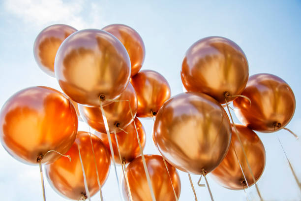 istock Golden balloons on a cloudy blue sky background 1500634634