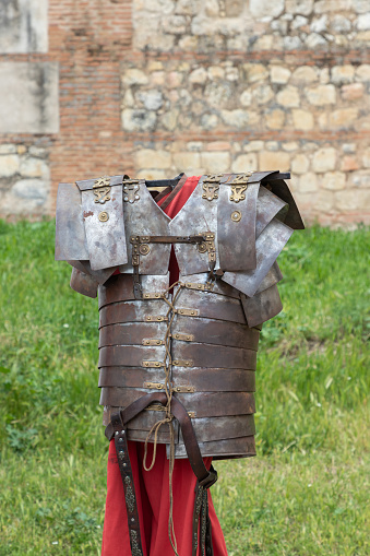 outdoor scene in vertical view of armor, tunic and belt of soldier from ancient roman empire, lorica segmentata, tunic and cingulum militare