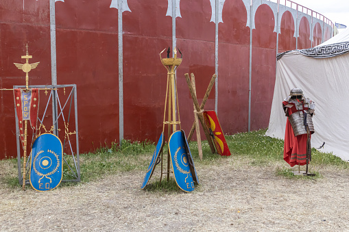 outdoor scene in horizontal view with shields and clothing of legionary soldier of the ancient roman empire. festival dedicated to the ancient roman empire in the city of alcala de henares, spain