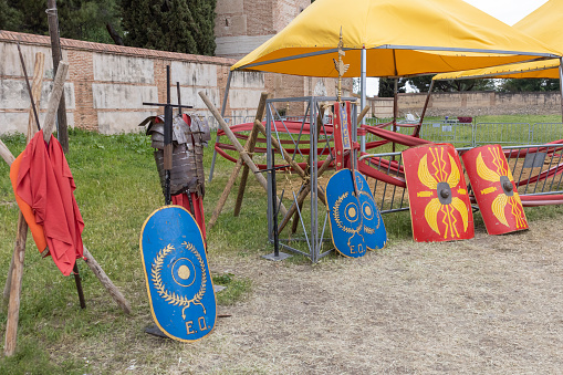 outdoor scene in horizontal view with shields and clothing of legionary soldier of the ancient roman empire. festival dedicated to the ancient roman empire in the city of alcala de henares, spain