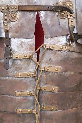 foreground detail photography in vertical view of armor af a soldier froma ancient roman empire, lorica segmentata