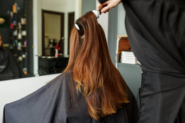istock Barber dries hair. Making hairstyle using hair dryer. 1500641601